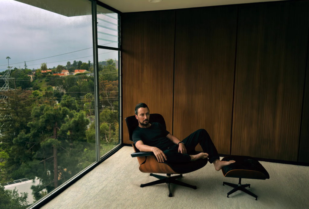 Photo of Anthony Vaccarello lounging, by Annie Leibovitz.
